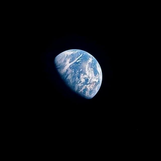 The Earth seen from space, alone in the dark.